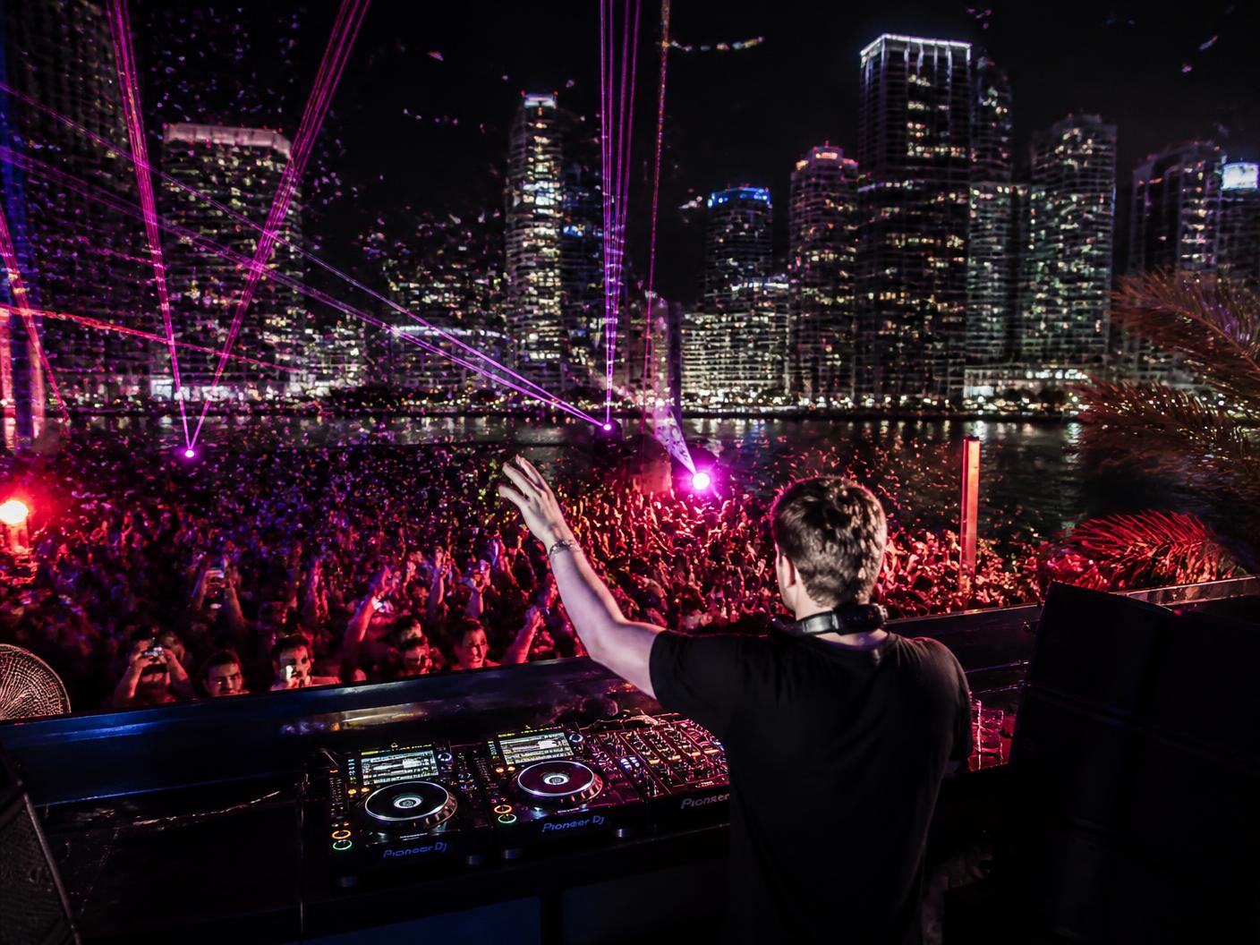 DJ performing at a rooftop night party in Miami
